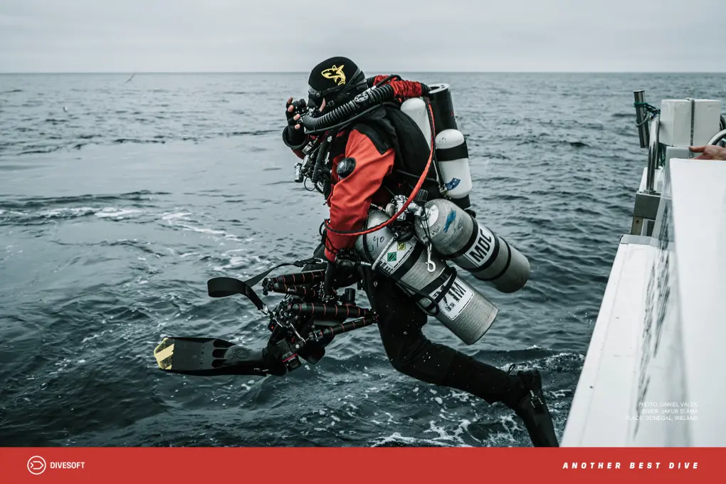 Diver with CCR (Closed Circuit Rebreather) jumping from a boat into the water