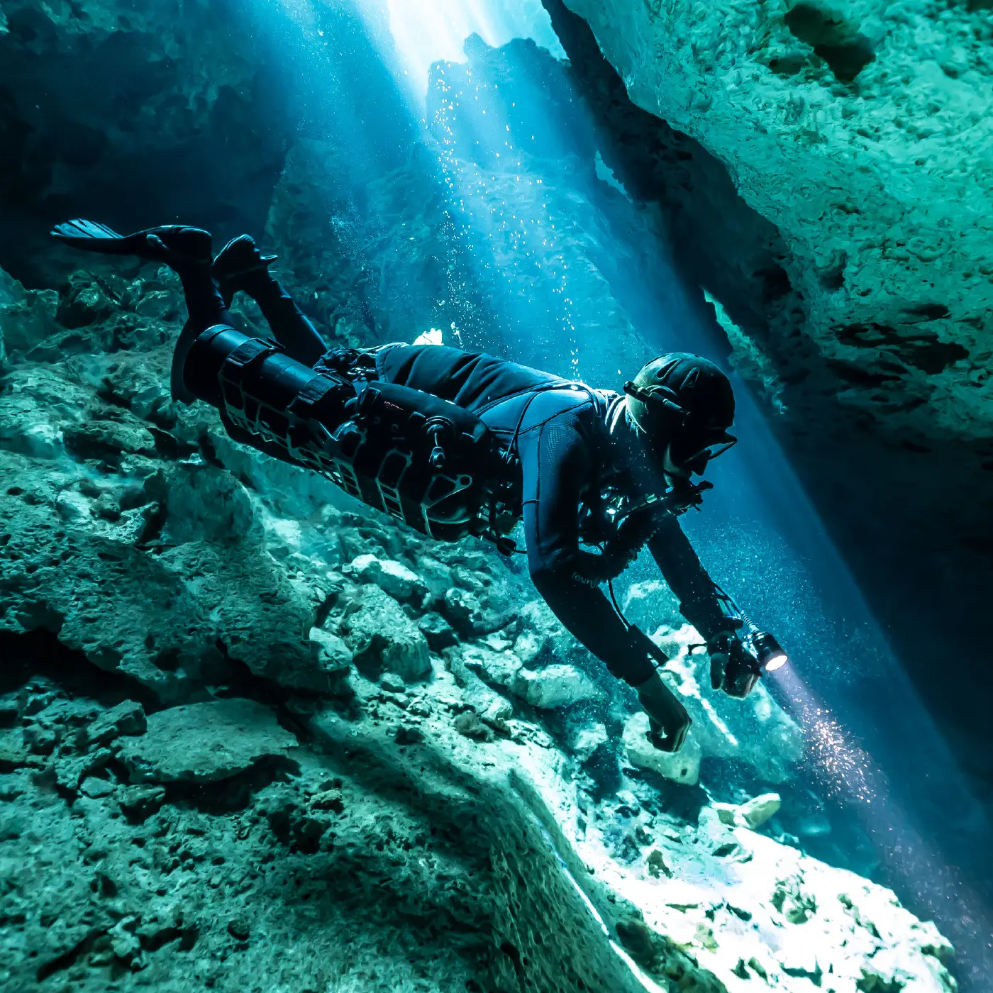 A CCR diver exploring underwater without a continuous stream of bubbles.